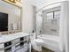 Modern bathroom featuring a bathtub with marble surround and mirrored vanity at 2104 Plaza De La Candela, Las Vegas, NV 89102
