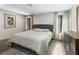 Comfortable bedroom featuring a tufted headboard, soft colors, and natural light at 2104 Plaza De La Candela, Las Vegas, NV 89102