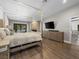 Inviting bedroom boasts a stone fireplace, a TV, and a sliding glass door to outside at 2104 Plaza De La Candela, Las Vegas, NV 89102