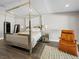 Bright bedroom features a four poster bed, an accent chair, and modern furnishings at 2104 Plaza De La Candela, Las Vegas, NV 89102