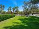A beautifully kept green common ground features mature shade trees and bushes with a blue sky overhead at 2104 Plaza De La Candela, Las Vegas, NV 89102
