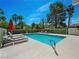 Community pool area with lounge chairs, tables, mature trees, and well-manicured hedges offers a resort atmosphere at 2104 Plaza De La Candela, Las Vegas, NV 89102