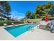 Enjoy the community pool area with plenty of seating, lounge chairs, mature trees, and a gazebo for relaxing at 2104 Plaza De La Candela, Las Vegas, NV 89102