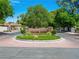 Community entrance sign displaying 'Spanish Oaks' set amidst well-maintained landscaping and brick-paved roundabout at 2104 Plaza De La Candela, Las Vegas, NV 89102