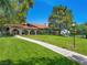 Manicured lawn and walkway leading to a beautiful building with arches and a terracotta roof at 2104 Plaza De La Candela, Las Vegas, NV 89102