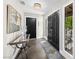 Inviting foyer with black double doors, artwork, hall table, and a view of the front patio through an iron-clad window at 2104 Plaza De La Candela, Las Vegas, NV 89102