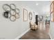 Bright hallway with decor mirrors, an armchair, and a view into the kitchen and living areas at 2104 Plaza De La Candela, Las Vegas, NV 89102