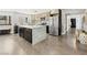 Bright kitchen features stainless steel refrigerator, granite island, and modern appliances at 2104 Plaza De La Candela, Las Vegas, NV 89102