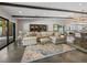 Comfortable living room with exposed beams, plush seating, and seamless access to the outdoor patio at 2104 Plaza De La Candela, Las Vegas, NV 89102