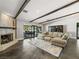 Cozy living room with exposed beams, fireplace, and seamless access to the outdoor patio at 2104 Plaza De La Candela, Las Vegas, NV 89102