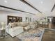 Open-concept living room featuring exposed beams, a large sectional sofa, and an elegant area rug at 2104 Plaza De La Candela, Las Vegas, NV 89102