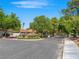 Street view of the 'Spanish Oaks' community with well-maintained landscaping and mature trees at 2104 Plaza De La Candela, Las Vegas, NV 89102