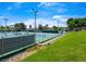 Multiple lighted tennis courts surrounded by trees and green landscaping enhance the community amenities at 2104 Plaza De La Candela, Las Vegas, NV 89102