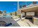 Backyard featuring a luxurious pool, spa, fire pit, and covered patio with outdoor kitchen at 2124 Pont National Dr, Henderson, NV 89044