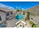 Aerial view of backyard with pool, firepit, patio and desert landscaping at 2124 Pont National Dr, Henderson, NV 89044
