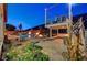 Beautiful outdoor space featuring a pool, fire pit, and lush landscaping at 2124 Pont National Dr, Henderson, NV 89044