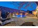 A luxurious swimming pool and outdoor kitchen are complemented by comfortable seating and relaxing sunbeds at 2124 Pont National Dr, Henderson, NV 89044