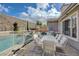 Backyard featuring a pool, outdoor seating, built-in grill, and mature landscaping at 2124 Pont National Dr, Henderson, NV 89044
