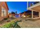 Scenic backyard with water feature, outdoor kitchen, fireplace, and cozy lounge area at 2124 Pont National Dr, Henderson, NV 89044