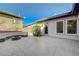 Spacious backyard featuring a built-in seating area with a fire pit and a large stamped concrete patio at 2124 Pont National Dr, Henderson, NV 89044