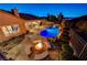 Gorgeous swimming pool, spa, and firepit, surrounded by lush landscaping at 2124 Pont National Dr, Henderson, NV 89044