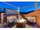 Relaxing upper balcony with stylish furniture around a fire pit feature at 2124 Pont National Dr, Henderson, NV 89044