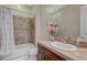 Bathroom showcases a single sink vanity and tiled shower-tub combination at 2124 Pont National Dr, Henderson, NV 89044