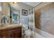 Bright bathroom features a single sink vanity and tiled shower-tub combination at 2124 Pont National Dr, Henderson, NV 89044