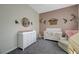 ' bedroom features plush carpeting, a crib, daybed, and white dresser at 2124 Pont National Dr, Henderson, NV 89044