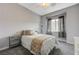 Well lit bedroom features plush carpeting, grey walls and large window at 2124 Pont National Dr, Henderson, NV 89044