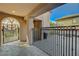Charming courtyard entrance featuring a decorative gate and a cozy outdoor seating area with a fire pit at 2124 Pont National Dr, Henderson, NV 89044