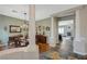 Elegant dining room featuring a chandelier, dark wood furniture, and access to other rooms at 2124 Pont National Dr, Henderson, NV 89044