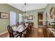 Charming dining room with wood floors, an antique table, and a view into the butler's pantry at 2124 Pont National Dr, Henderson, NV 89044