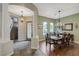 Inviting entryway with tile and wood flooring, staircase, dining area, and decorative lighting at 2124 Pont National Dr, Henderson, NV 89044