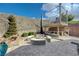 Backyard with a custom fire pit, waterfall feature, and built-in outdoor kitchen at 2124 Pont National Dr, Henderson, NV 89044