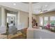 Bright hallway with decorative columns, wood flooring, and a view of the fireplace and backyard at 2124 Pont National Dr, Henderson, NV 89044