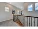 Bright hallway featuring natural light and decorative railings on the stairs at 2124 Pont National Dr, Henderson, NV 89044