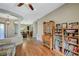 Well-lit hallway featuring hardwood floors, a bookshelf, and seamless transition to the dining area at 2124 Pont National Dr, Henderson, NV 89044
