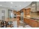 Spacious kitchen with granite counters, stainless steel appliances, custom cabinets, and an island with seating at 2124 Pont National Dr, Henderson, NV 89044