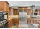 Well-appointed kitchen with stainless steel appliances, including a large refrigerator and custom wood cabinets at 2124 Pont National Dr, Henderson, NV 89044