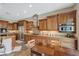 Spacious kitchen featuring custom cabinets, granite countertops, stainless steel appliances, and an island with seating at 2124 Pont National Dr, Henderson, NV 89044