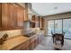 Beautiful kitchen featuring granite countertops, stainless steel appliances, and a gas cooktop with views of the pool at 2124 Pont National Dr, Henderson, NV 89044
