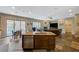 Open-concept living area featuring a kitchen island and a view of the backyard with access to the backyard at 2124 Pont National Dr, Henderson, NV 89044