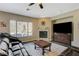 Comfortable living room with natural light, a cozy fireplace, and views of the pool at 2124 Pont National Dr, Henderson, NV 89044