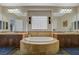 Luxurious bathroom with a garden tub, double vanities, and stylish fixtures at 2124 Pont National Dr, Henderson, NV 89044