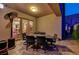 Covered patio is furnished with a table with chairs, perfect for outdoor dining at 2124 Pont National Dr, Henderson, NV 89044