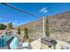 Inviting patio with fire pit, seating, and views of pool and desert landscape at 2124 Pont National Dr, Henderson, NV 89044
