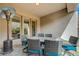 Covered patio offers a table with chairs for outdoor dining and relaxing at 2124 Pont National Dr, Henderson, NV 89044
