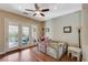 Bright playroom with wood floors, French doors to the patio, and a ceiling fan at 2124 Pont National Dr, Henderson, NV 89044