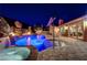 A beautiful swimming pool and spa, with an outdoor kitchen and outdoor dining table at 2124 Pont National Dr, Henderson, NV 89044